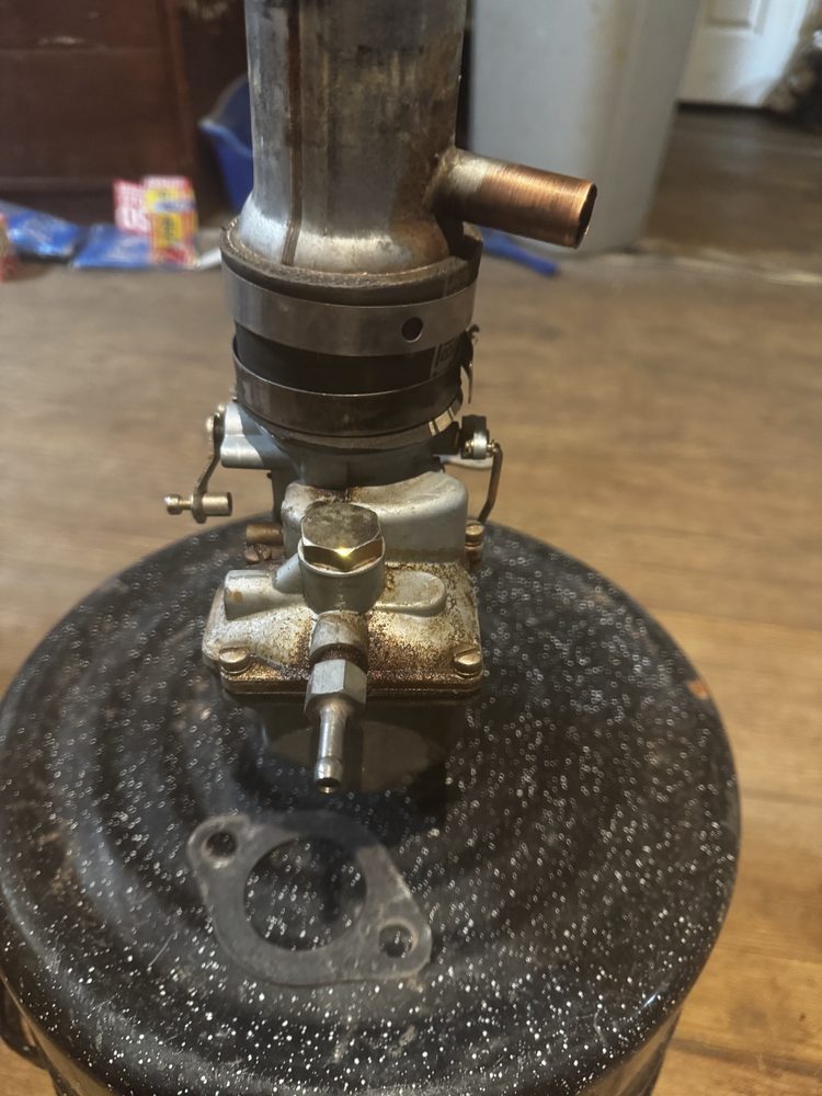 Top-down bench view of Hex Filter Plug 15, fuel inlet elbow, and flange gasket 69