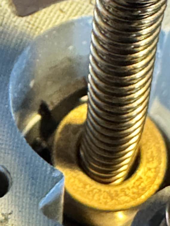 IMG_3038 Macro catching a black foam flake wedged at 6-8 o'clock between brass accelerating pump collar and aluminum cylinder wall